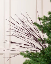 Purple Glitter Wispy Spray with long, slender glitter-covered stems arranged in a fan shape on a Christmas tree