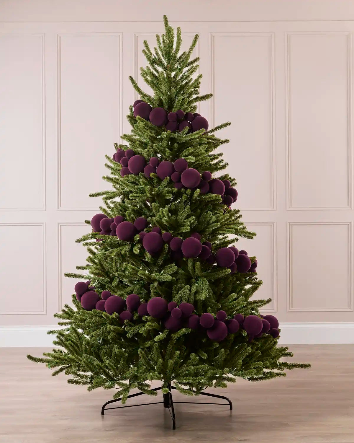 Purple Velvet Bauble Garland decorating a Christmas tree, featuring purple velvet baubles arranged along the garland.