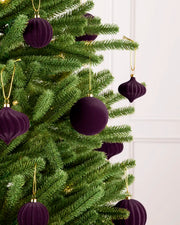 Purple velvet baubles decorating a Christmas tree, featuring soft purple velvet baubles