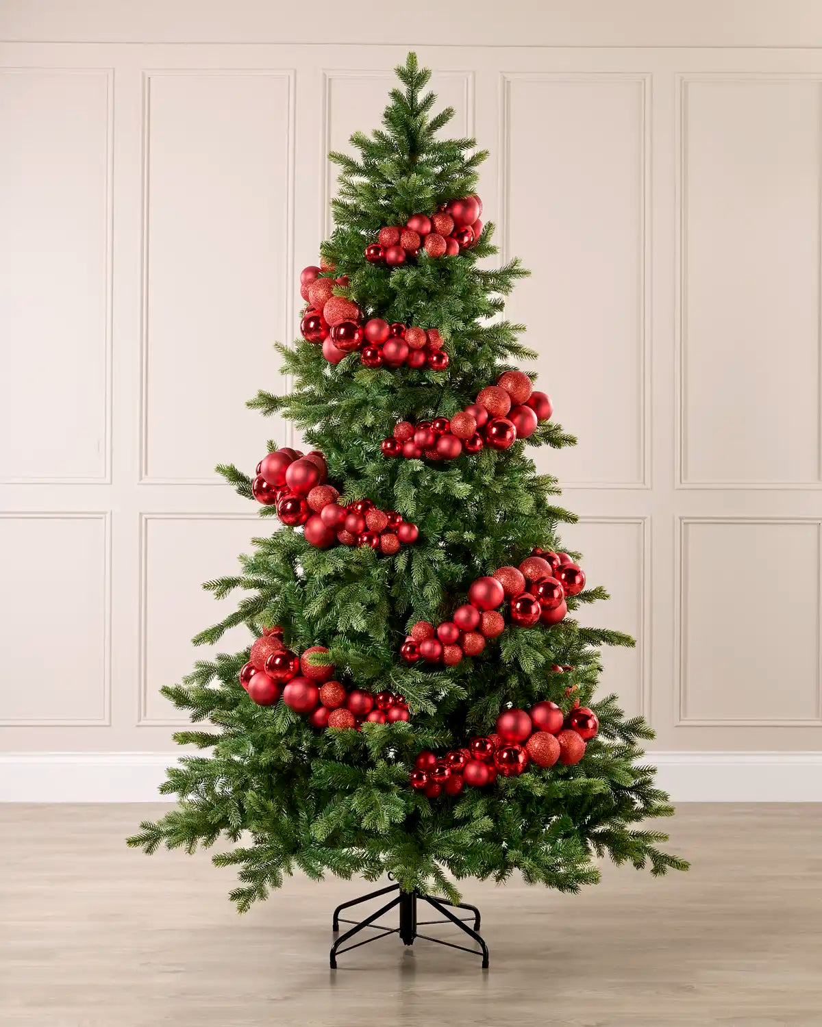 Red Bauble Cluster Arch decorating a Christmas tree, with glossy, matte, and glitter red baubles