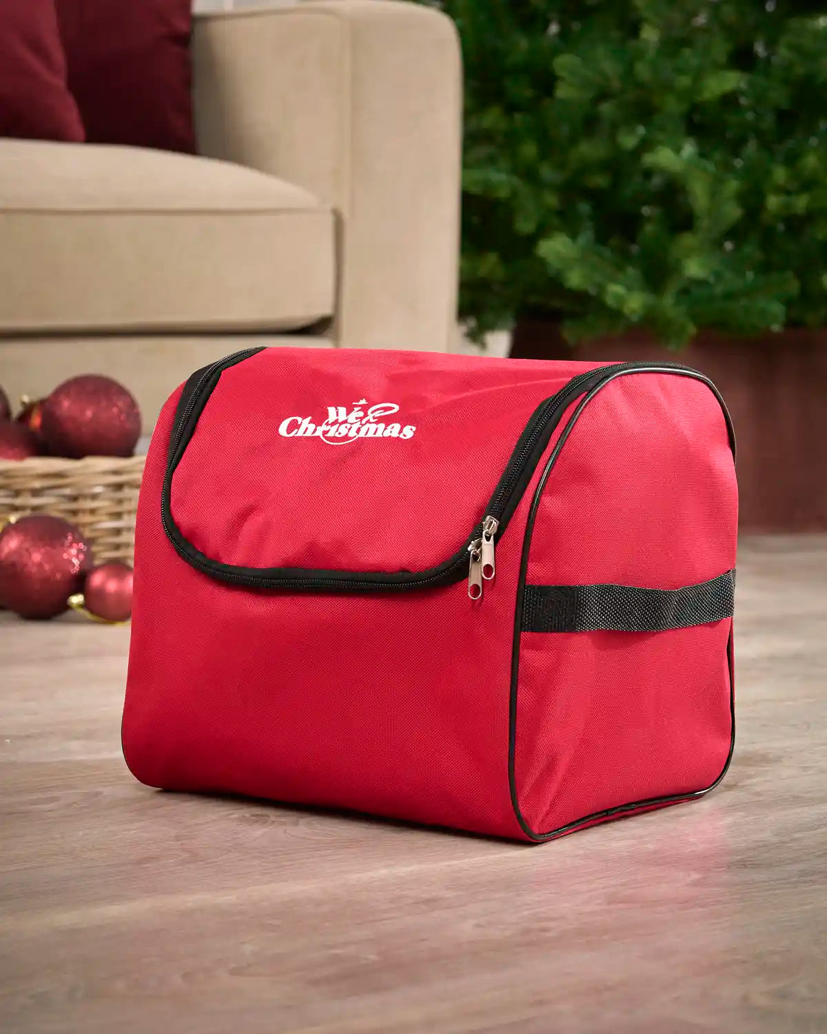 Red Fairy lights storage bag with Black trim on a wooden floor with a Christmas tree and Sofa in background