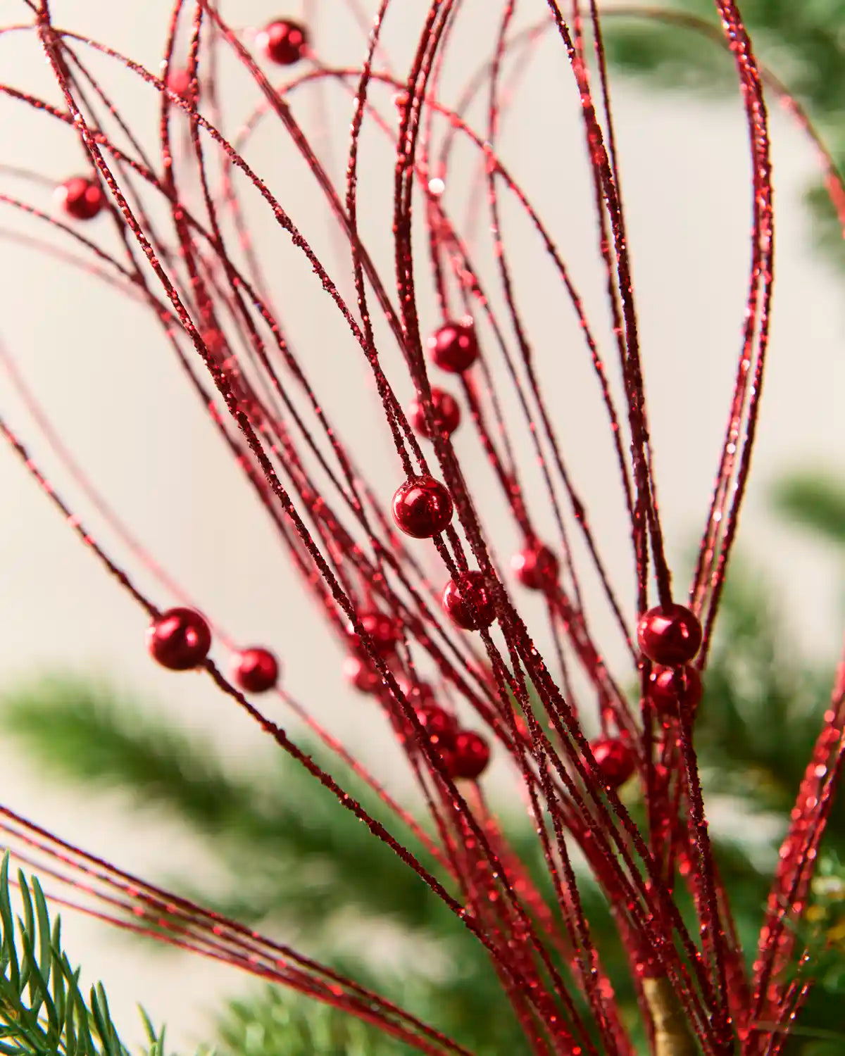 Close up Red Glitter Nest Christmas Tree Pick showing the glitter details and red balls.