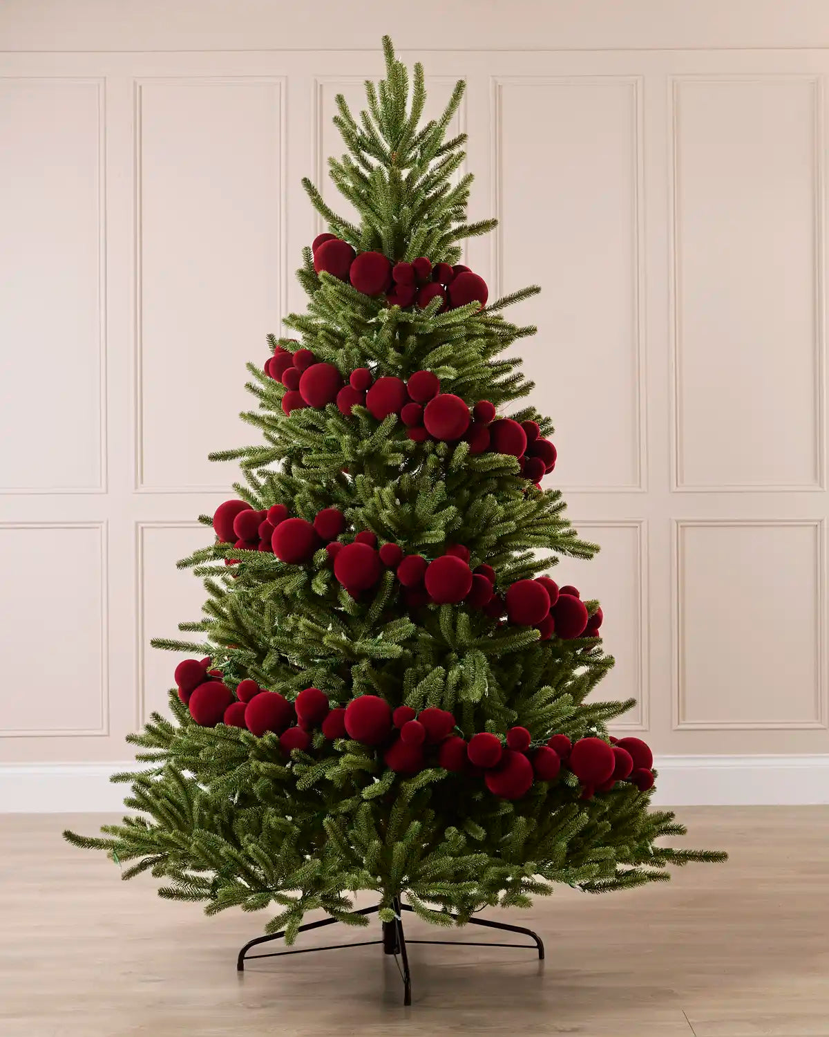 Red Velvet Bauble Garland decorating a Christmas tree, featuring red velvet baubles