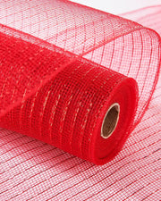 Red mesh fabric roll laying on more red fabric on a white table