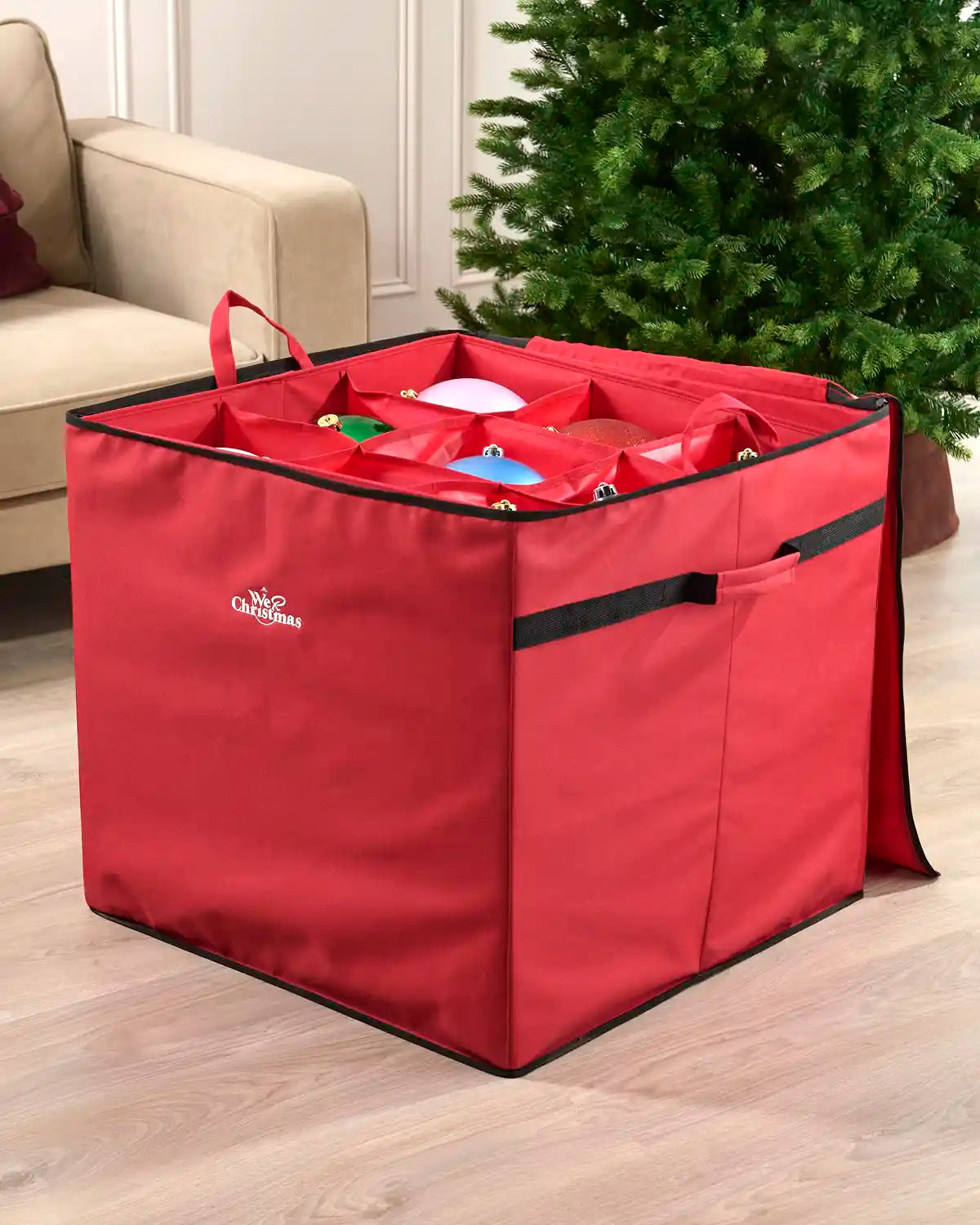 Red oversized Christmas decoration storage bag shown open with removable dividers and several baubles stored inside