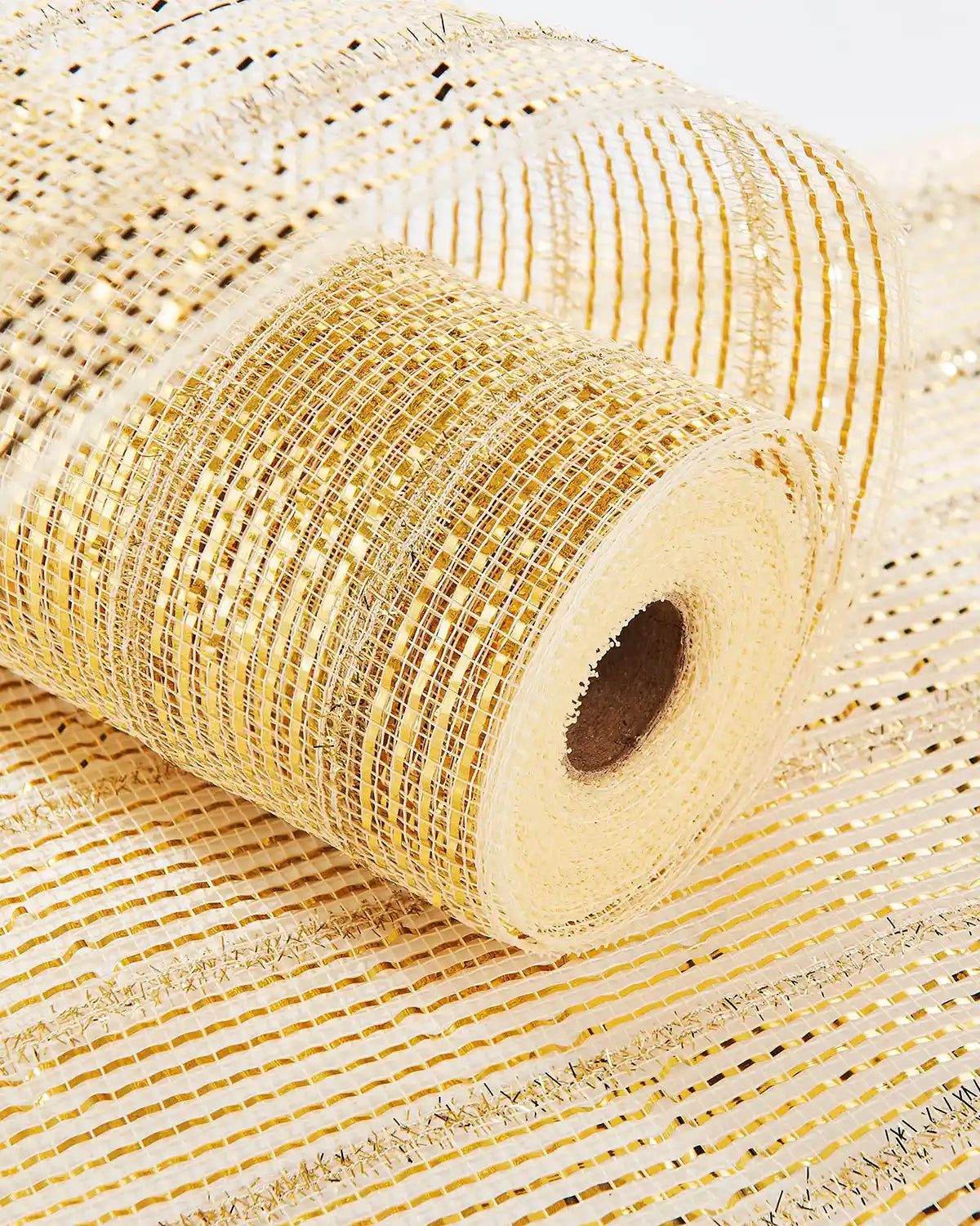 Roll of Ivory and gold mesh ribbon with a textured surface