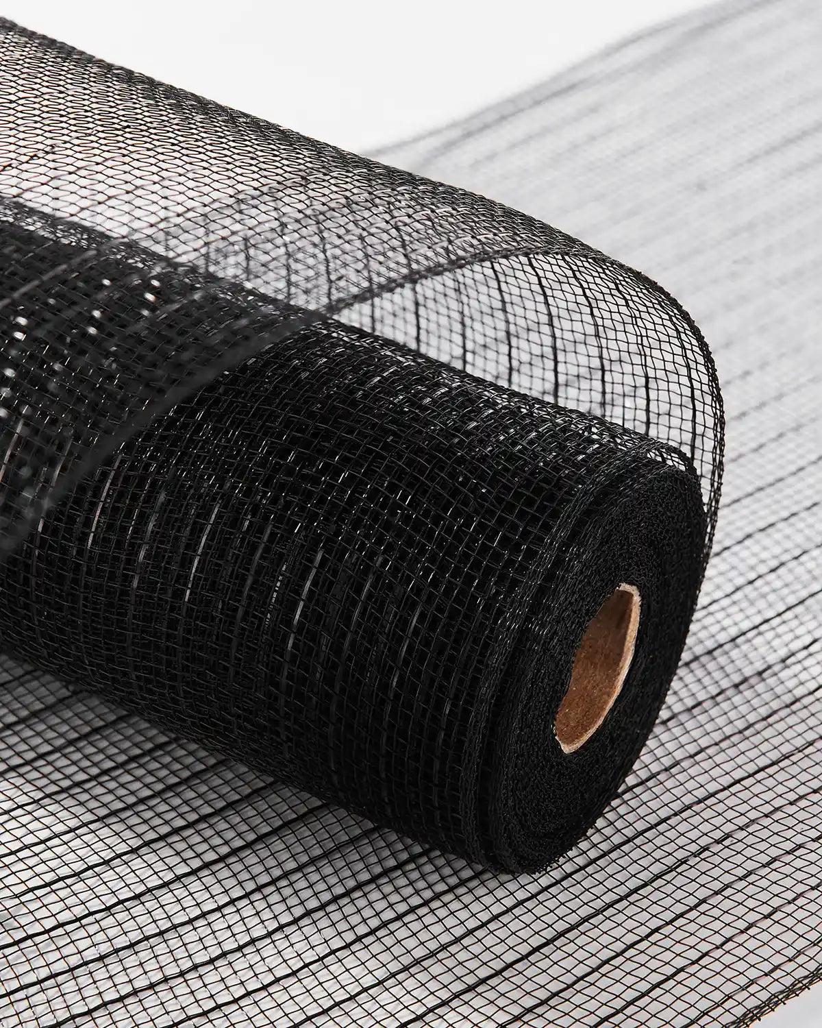 Roll of black mesh fabric on a white background