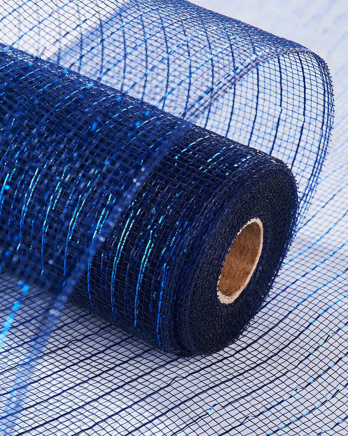 Roll of blue mesh fabric on a light blue background