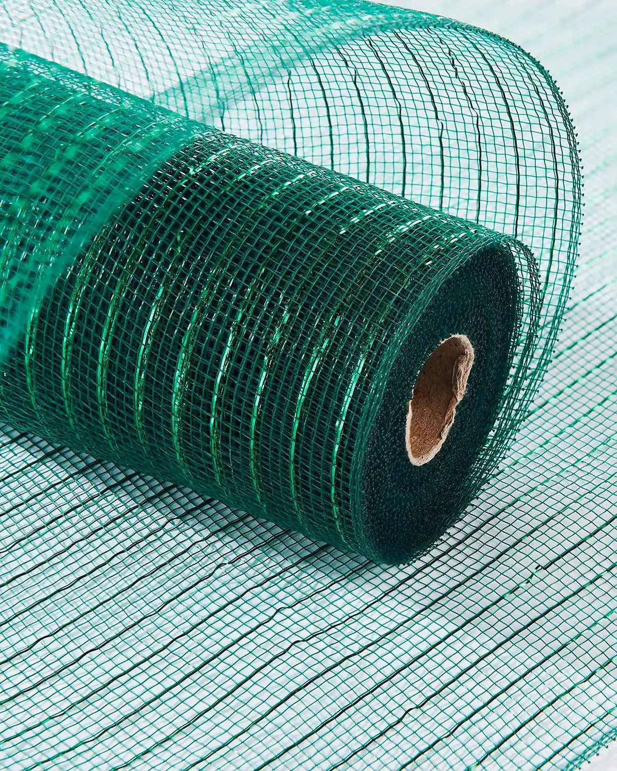 Roll of green wire mesh on a light white table