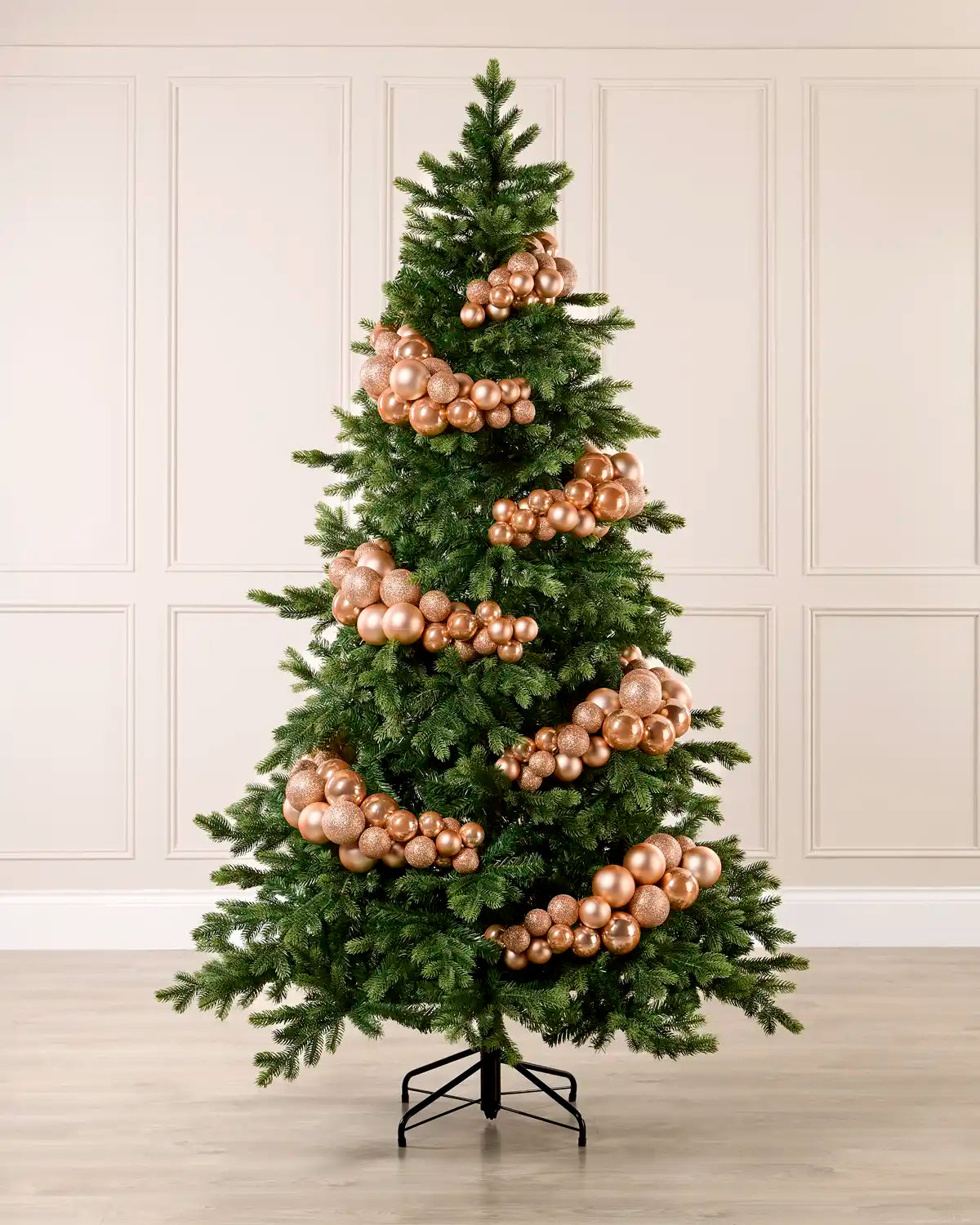 Rose Gold Bauble Cluster Arch decorating a Christmas tree, with glossy, matte, and glitter rose gold baubles