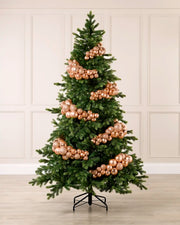 Rose Gold Bauble Cluster Arch decorating a Christmas tree, with glossy, matte, and glitter rose gold baubles