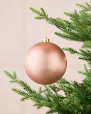 Rose gold oversized matt shatterproof bauble hanging on a Christmas tree, 15 cm
