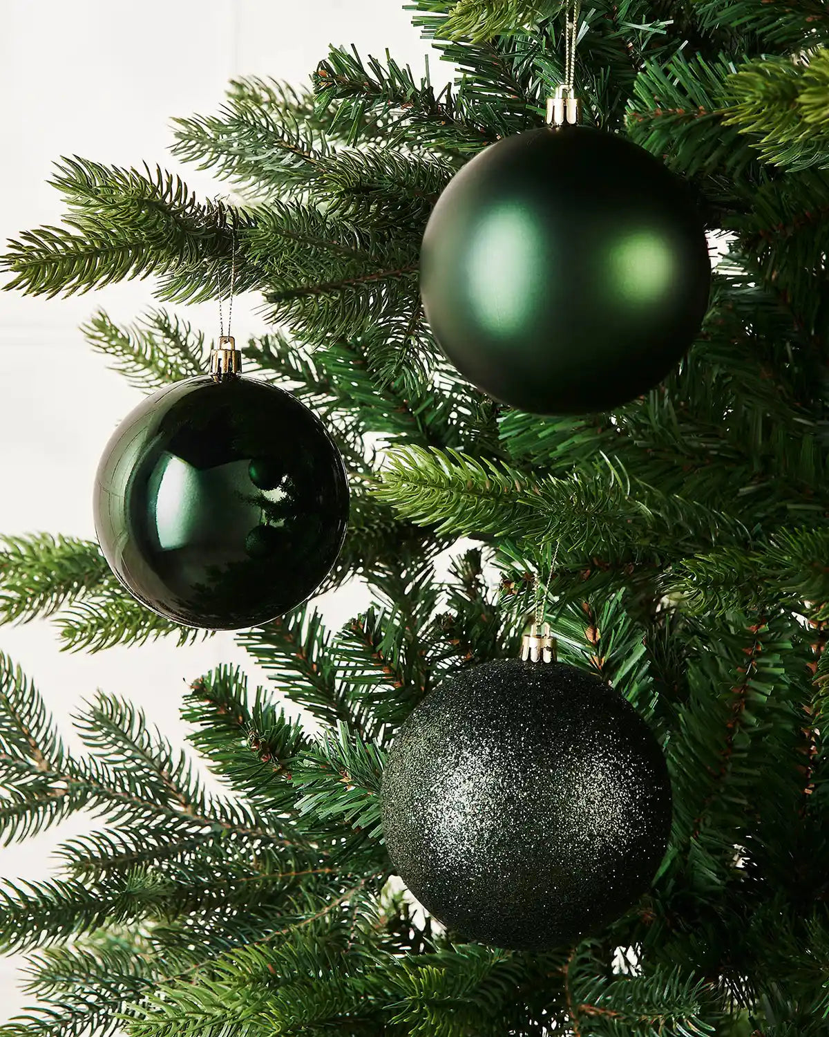 Sage Green Christmas baubles on a Christmas tree