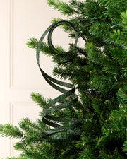 Sage Green Glitter Spiral Swirl Pick hanging from Christmas tree branch with cream background
