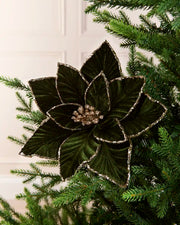 Sage Green oversized velvet artificial poinsettia displayed on a Christmas tree, featuring layered velvet petals with glittered edges and a sparkling center

