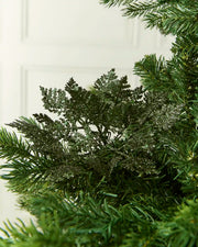 Sage green Glitter Leaf Pick placed in a Christmas tree