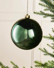 Sage green gloss oversized 15cm bauble on a Christmas tree branch