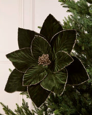 Sage green oversized velvet artificial poinsettia displayed on a Christmas tree, featuring layered velvet petals with glittered edges and a sparkling gold center