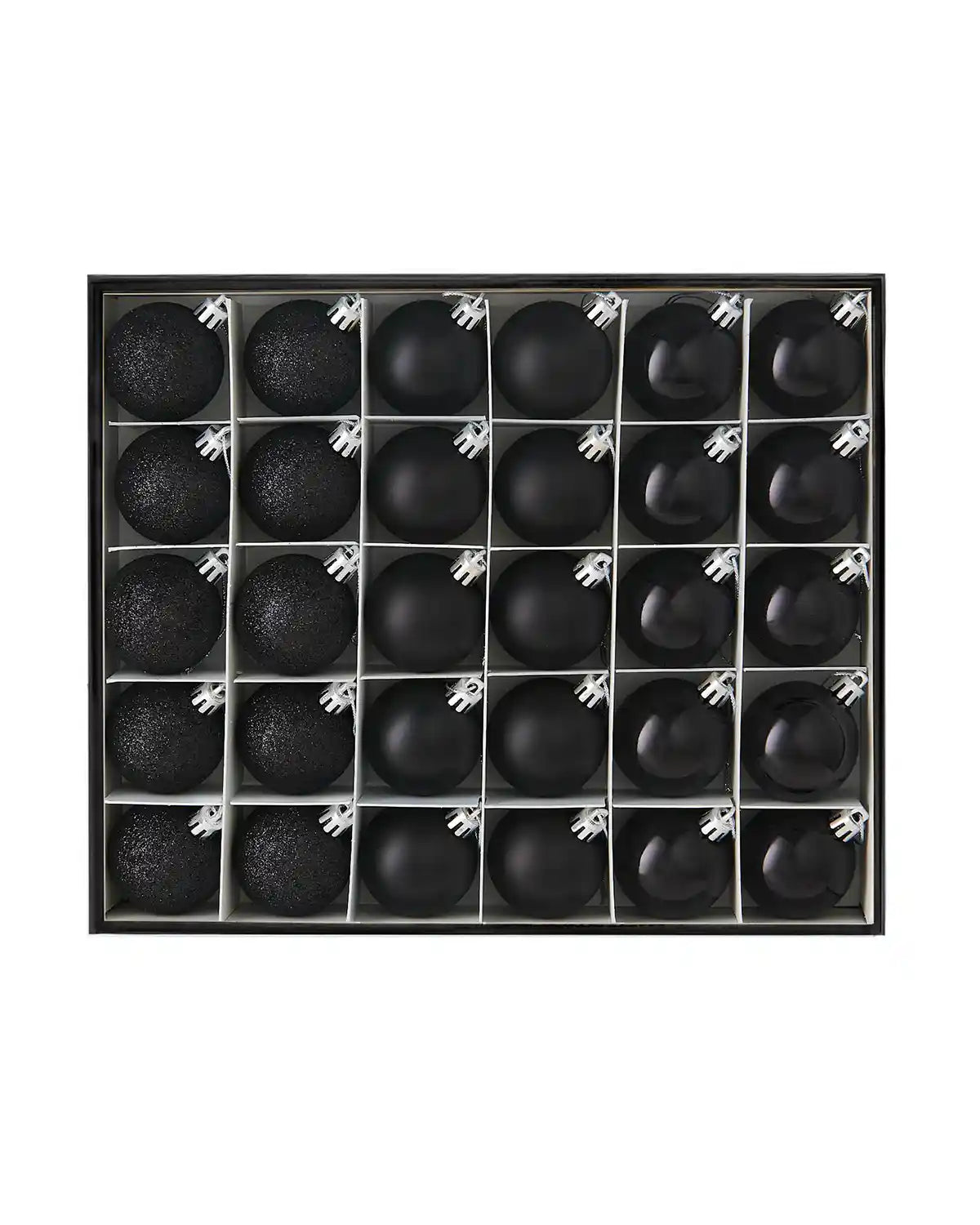 Set of 50 small black baubles in a black box against a white background