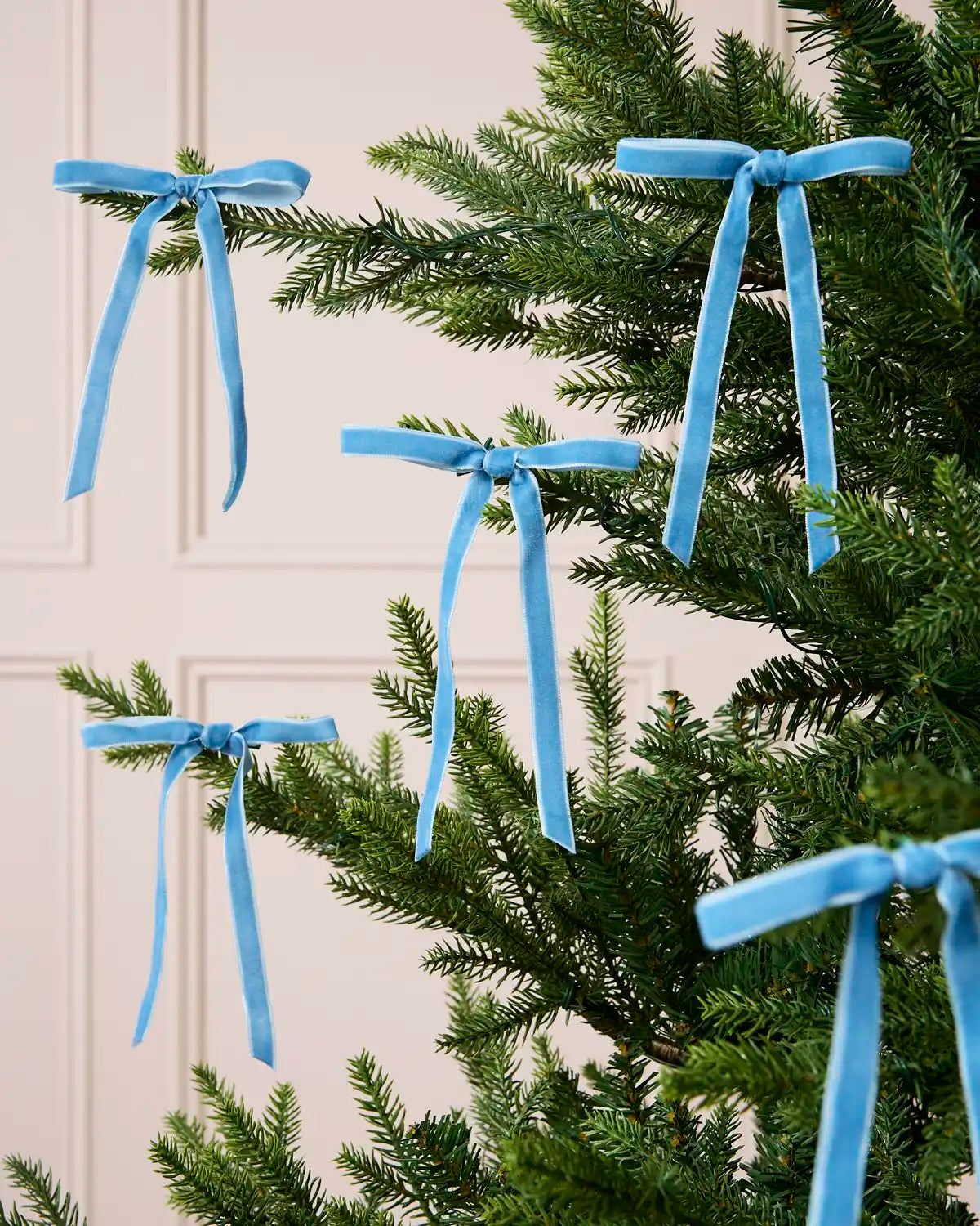 Set of Ice Blue Velvet Bows decorating a Christmas tree