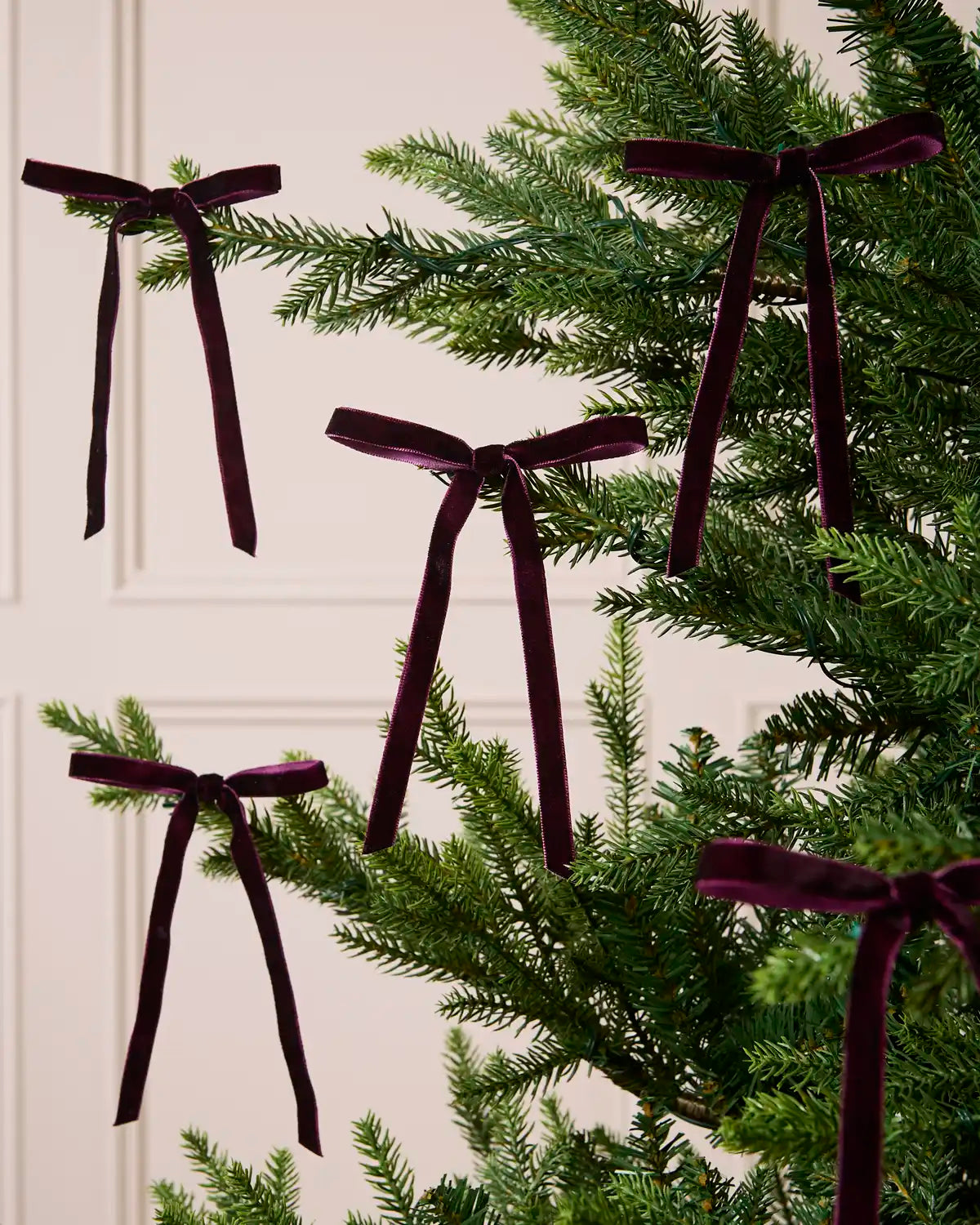 Set of Purple Velvet Bows decorating a Christmas tree