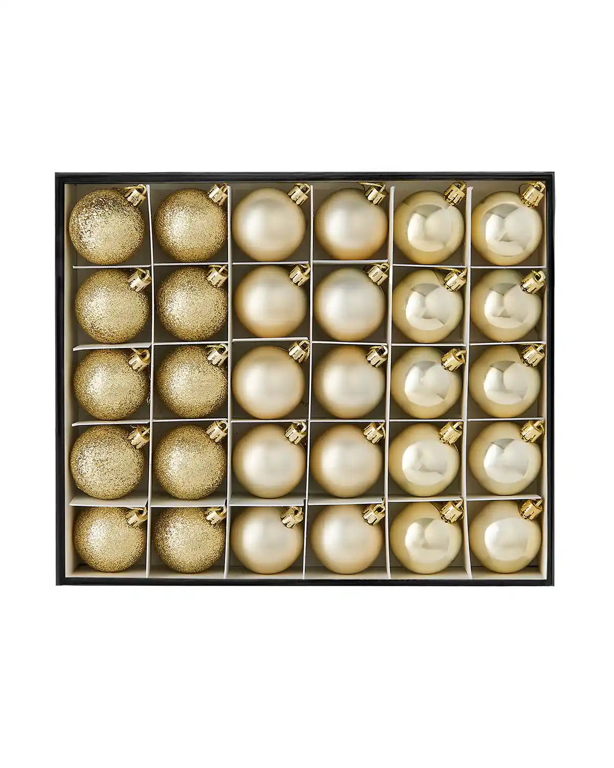 Set of gold Christmas baubles in a box on a white background