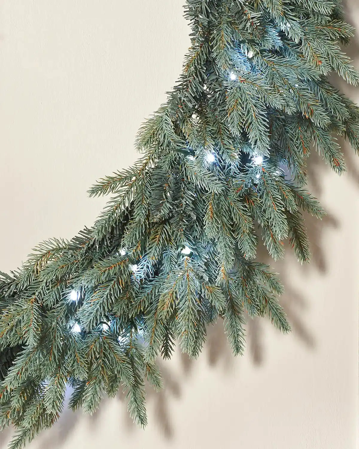 Side view of Pre-Lit Mixed Pine Blue Wreath, 1 m with Ice white lights