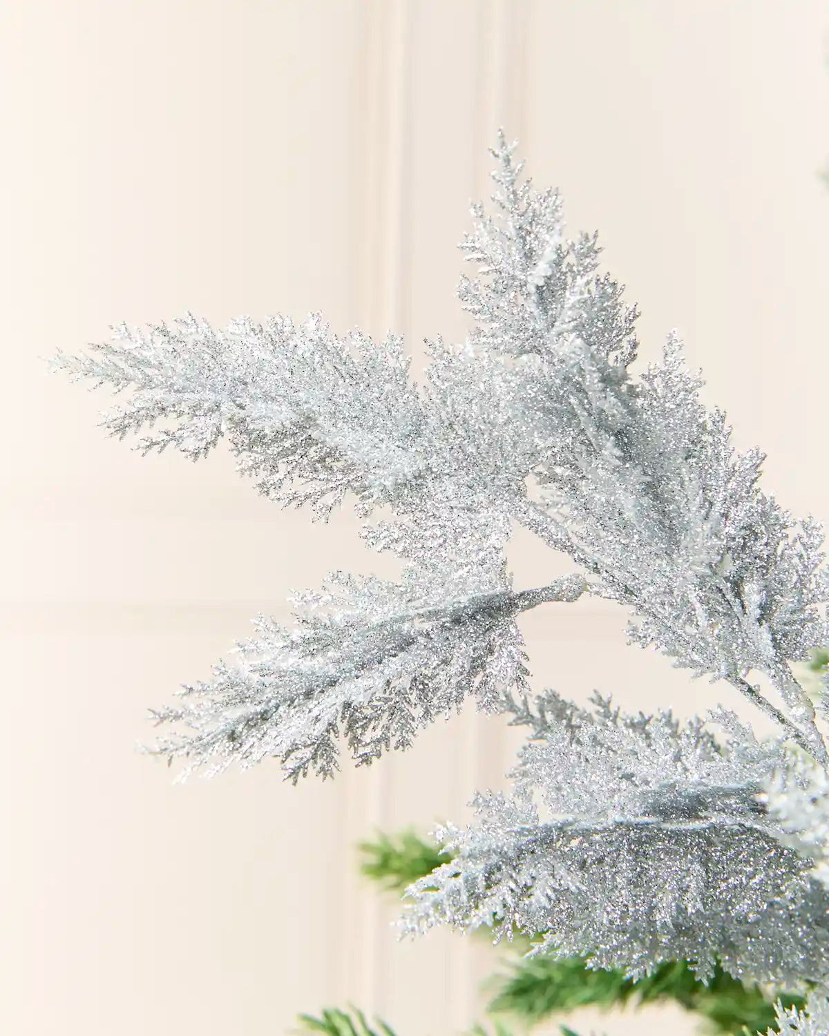 Silver Foliage Spray, glittering gold foliage on branching stems, shown in close-up to highlight its textured, shimmering leaves
