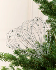 Silver Glitter Nest Christmas Tree Pick placed in green Christmas tree branches with a cream background

