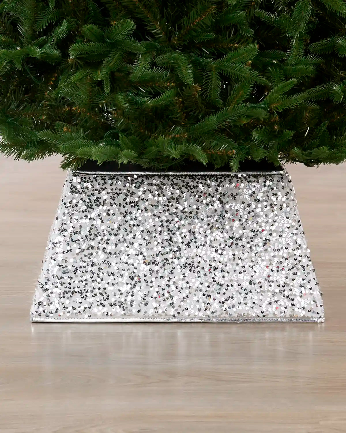 Silver Sequin Tree Collar surrounding the base of a Christmas tree