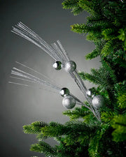 Silver glitter bauble spray inside tree with grey background