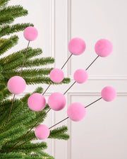 Velvet Bauble Picks in pink arranged on green Christmas tree branches