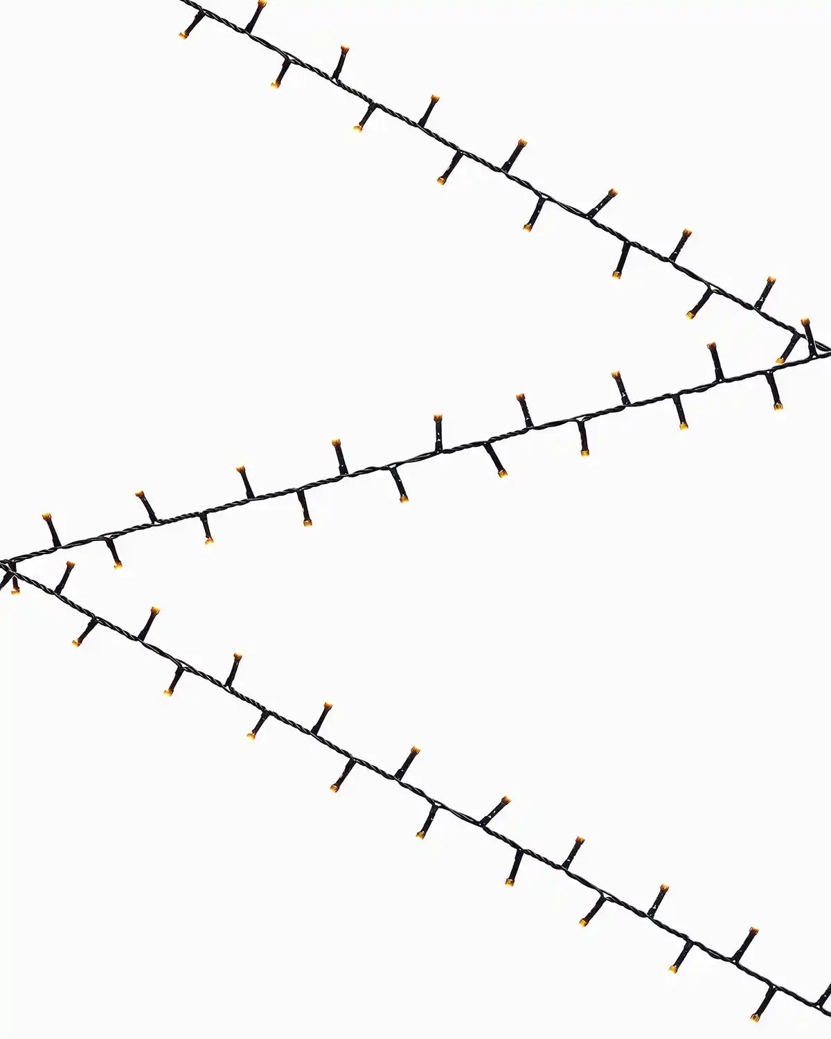Decorative warm white string lights on a white background in a zig zag formation