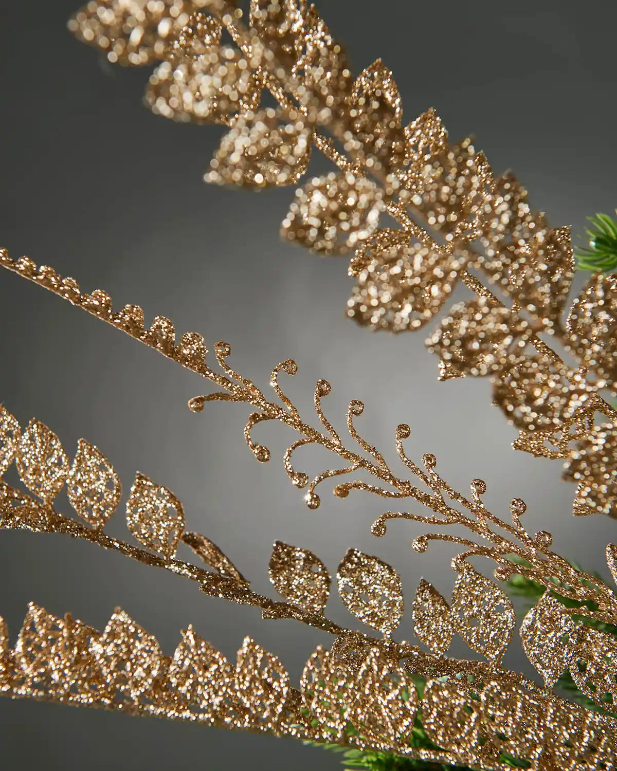 Close-up of a decorative gold branch with leaves on a dark background
