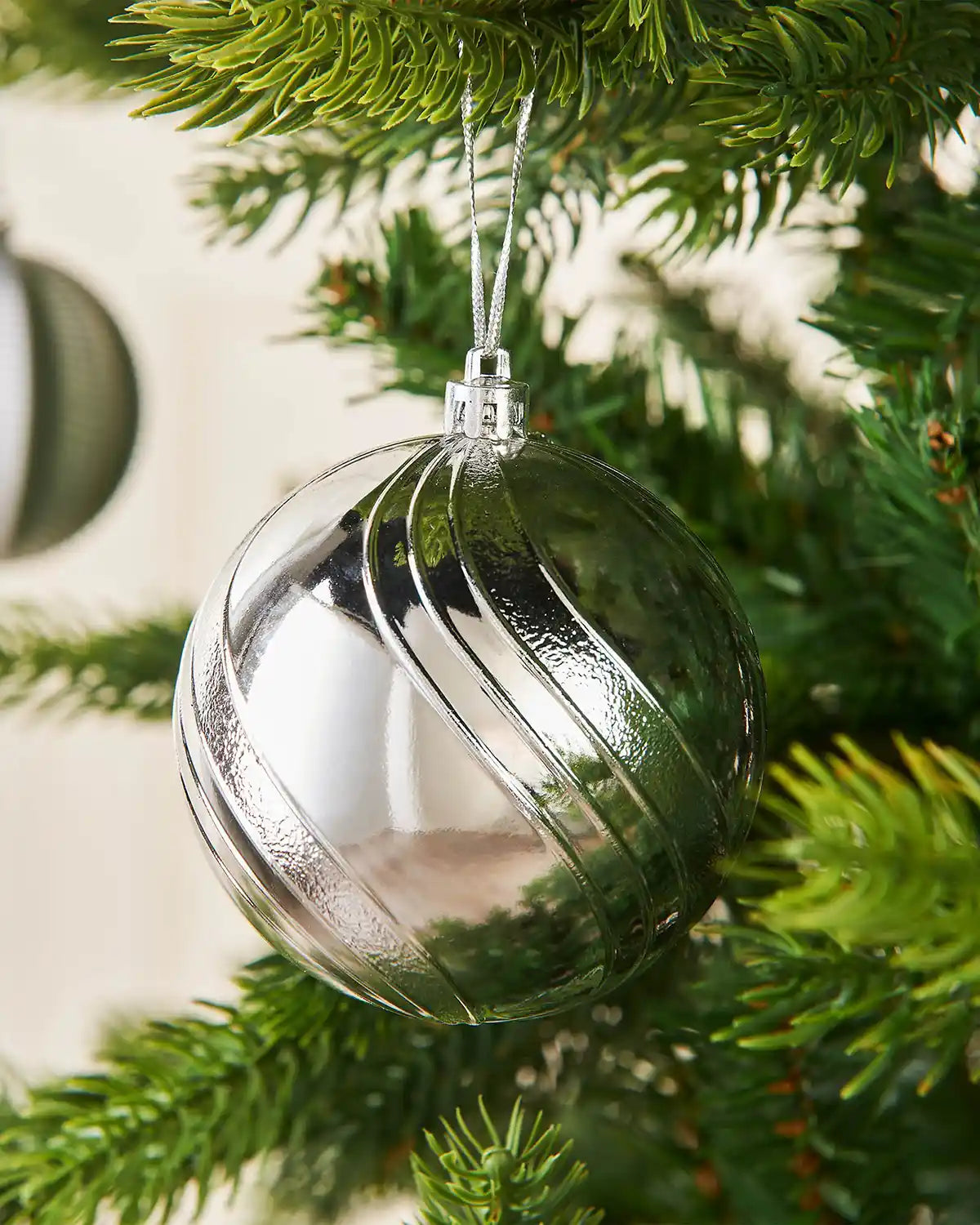 Close up Silver glass bauble on a Christmas tree