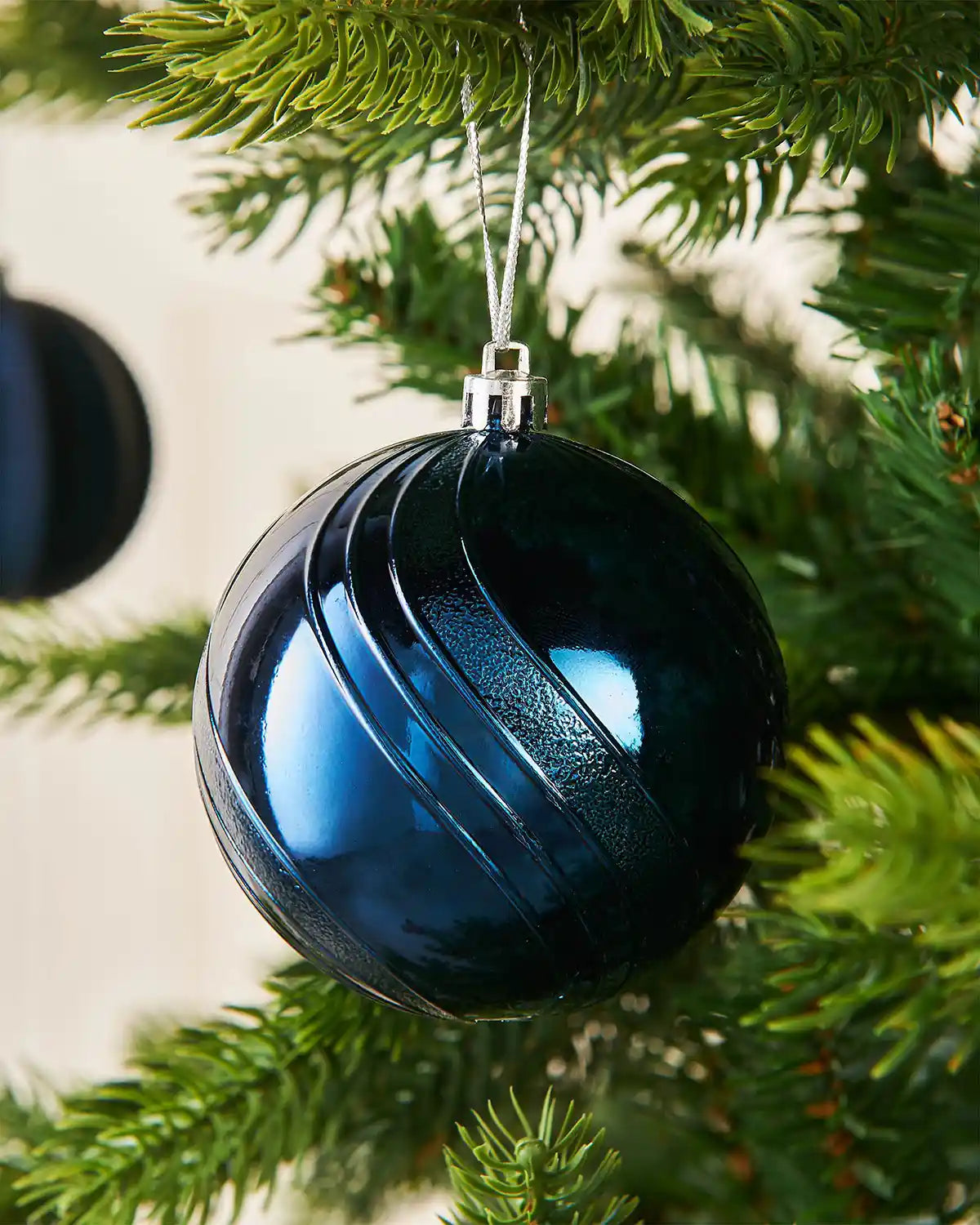 Blue Christmas ornament hanging on a tree