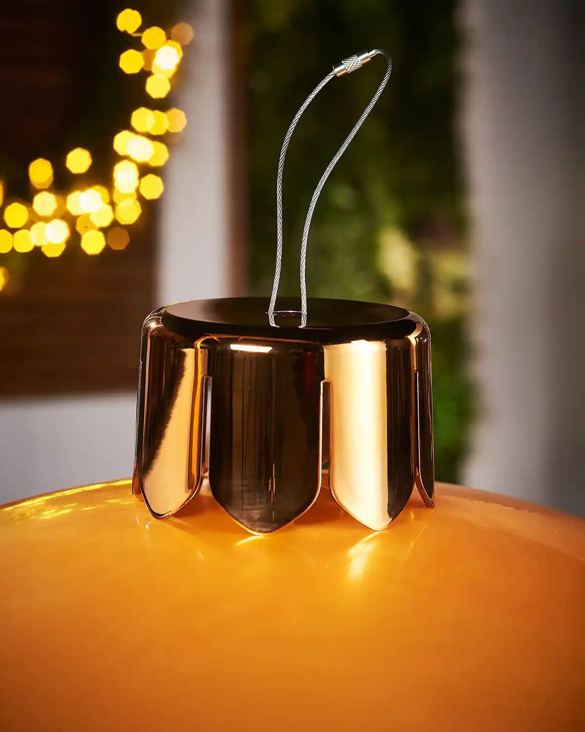 Close up of Gold crown on Gold inflatable bauble with blurred lights in the background