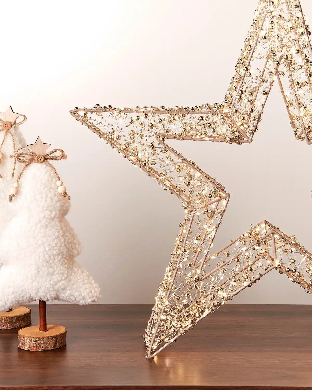 Decorative star-shaped light on a wooden surface with a neutral background