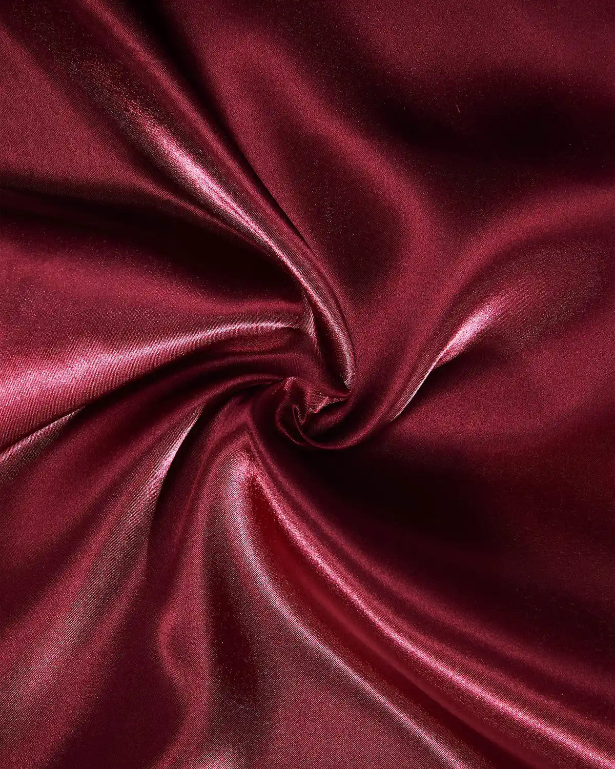 Close-up of burgundy satin fabric with a swirl pattern