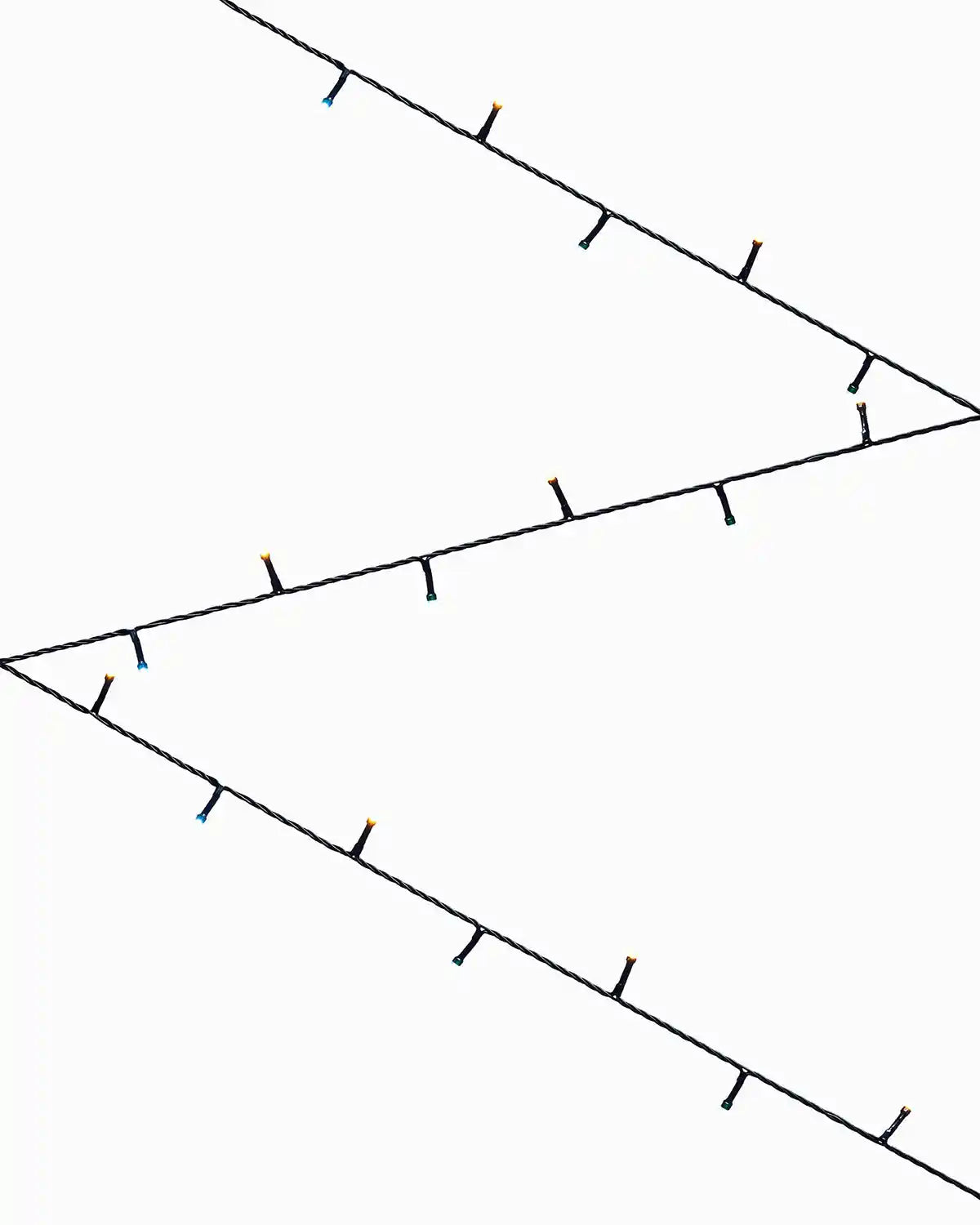 Warm white and Ice white string lights on a white background in a zig zag pattern