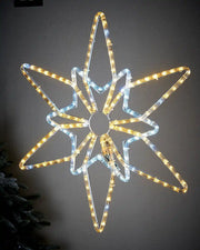 Warm white and ice white LED Northern star on light coloured garden wall