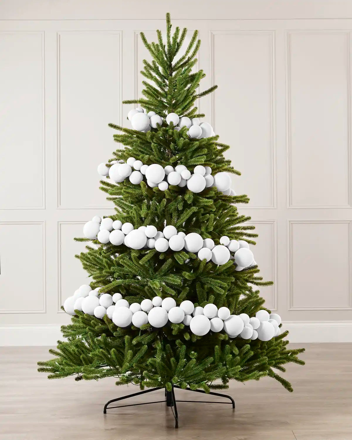 White Velvet Bauble Garland decorating a Christmas tree, featuring white velvet baubles arranged along the garland