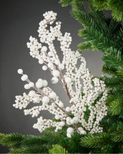 White berry cluster branch on a Christmas tree against a grey background