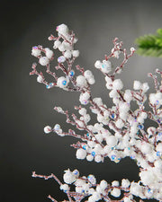 Close-up of white pearls crystal spray in front of grey wall background highlighting iridescent sequins