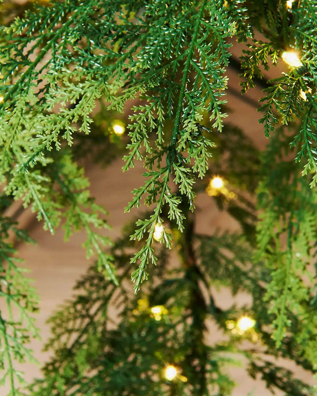 Close-up of 7.5ft pre-lit cypress fir branches with warm white light setting, highlighting branch details