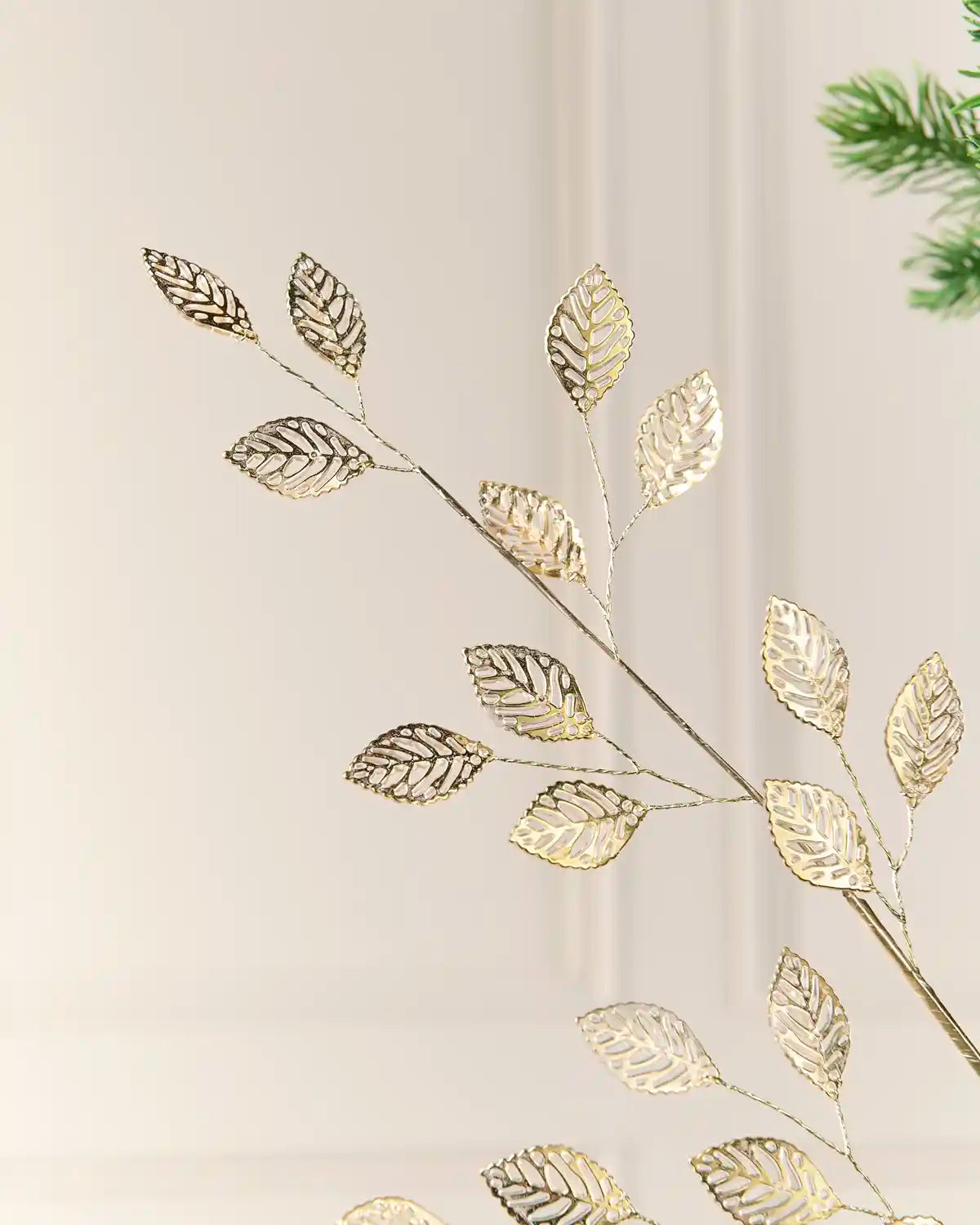 Antique gold Christmas tree leaf pick showing multiple openwork leaves along branching stems.