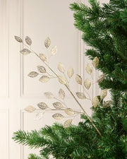 65 cm antique gold leaf pick arranged among green Christmas tree branches.