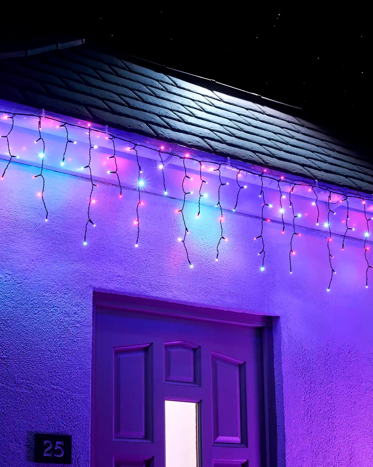Aurora icicle lights hanging above an exterior doorway at night.