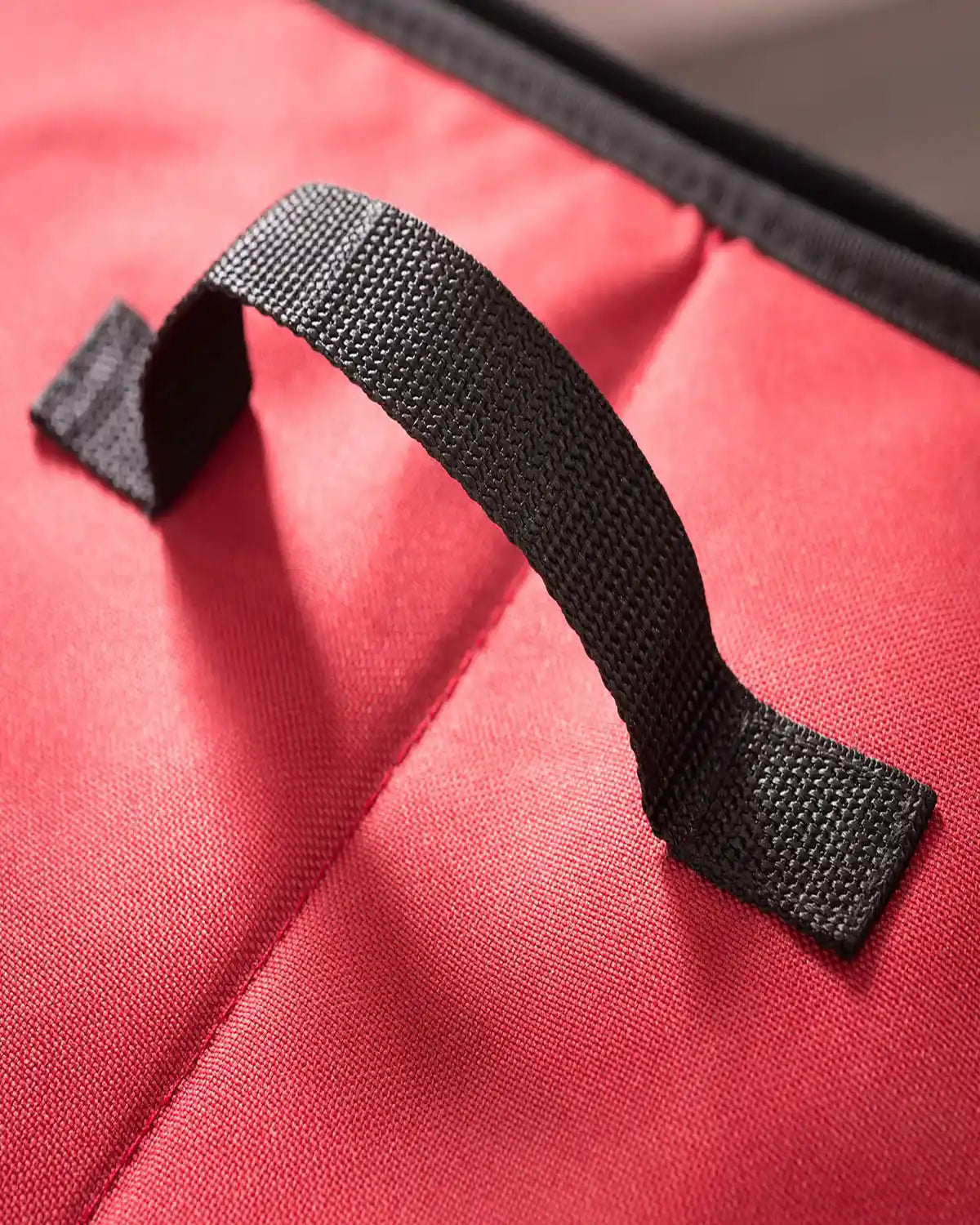 Close-up of the black handle on the red decoration storage box