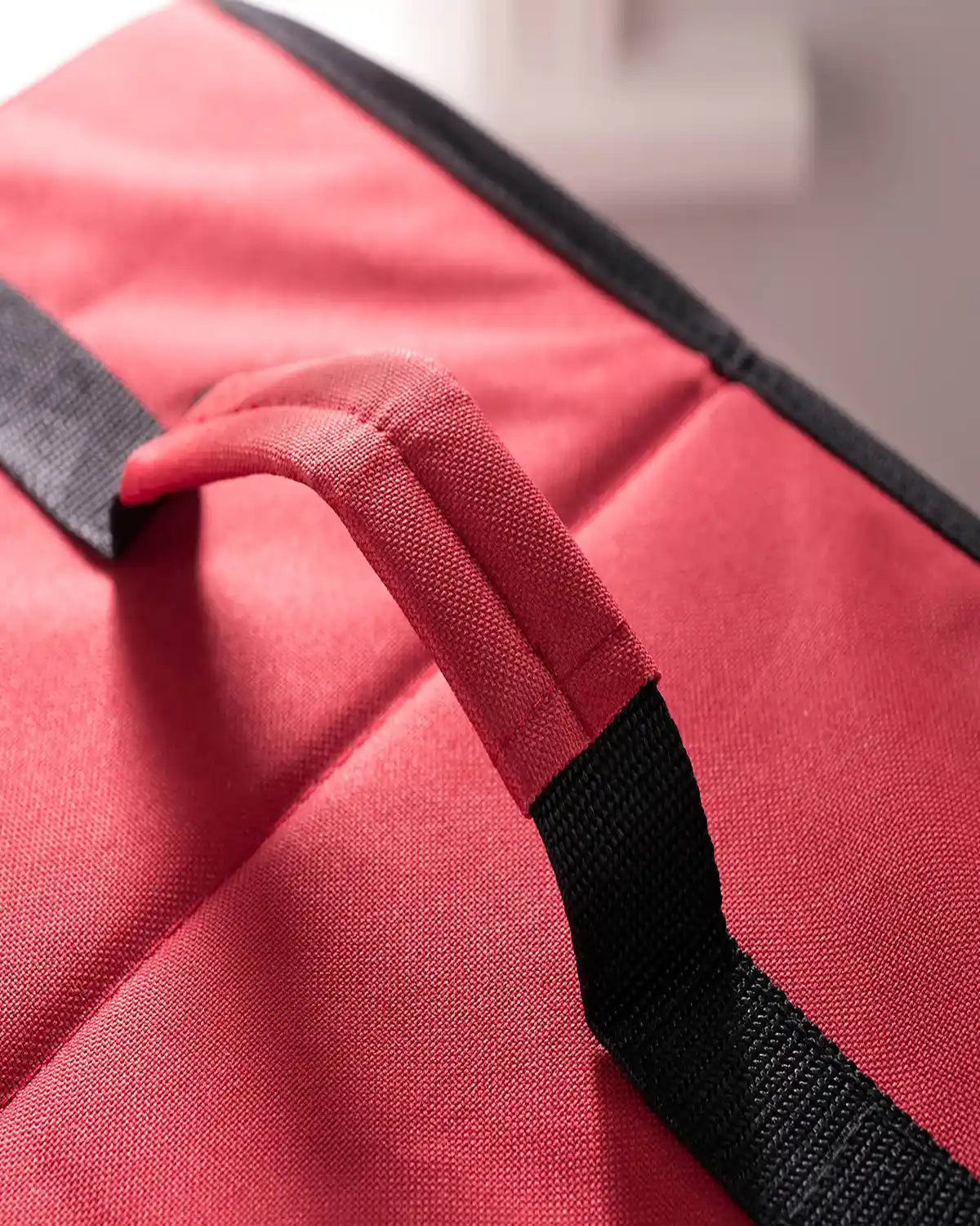 Close-up of the red decoration storage box with black and red carry handle